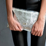 Symmetria leather clutch in silverANA KOUTSI