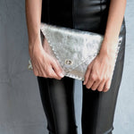 Symmetria leather clutch in silverANA KOUTSI